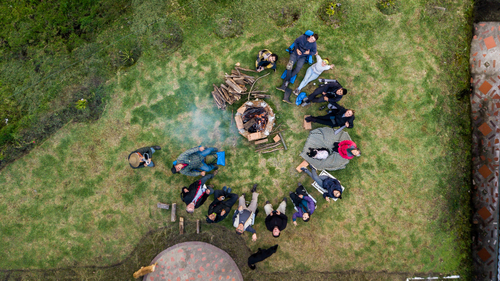 aerial-view-group-people-surrounding-fire-pit-campsite
